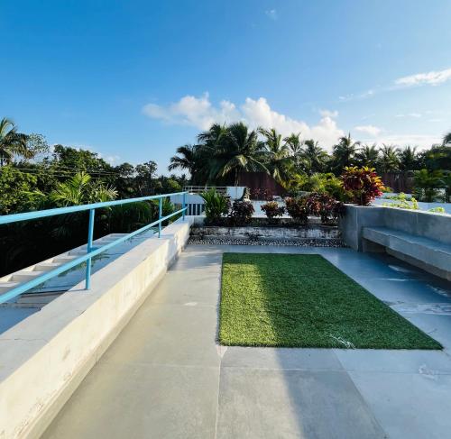 Blick vom Balkon eines Hauses mit Rasen in der Unterkunft B Shore by evaddo Luxury 3BHK Villa with Private Pool & Jacuzzi in Anjuna