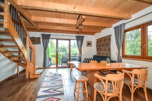 a living room with a wooden table and chairs at Tatrzańska Kotwica in Witów