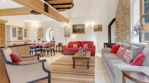 a living room with a couch and a table at The Stables, Batheaston in Batheaston