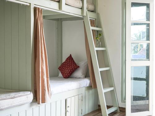a bunk bed in a room with a window at Dorm Room in Boutique Wellness Hotel in Mirissa
