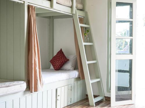 a bunk bed in a room with a window at Dorm Room in Boutique Wellness Hotel in Mirissa