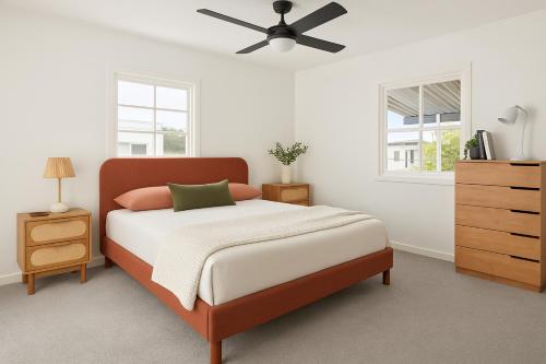a bedroom with a bed and a ceiling fan at Renovated 3-Bedroom Beach House Sunshine Coast in Golden Beach