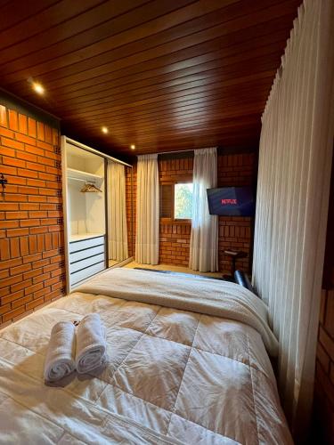 a bedroom with a large bed in a house at Oliveira mountain House in Tijucas