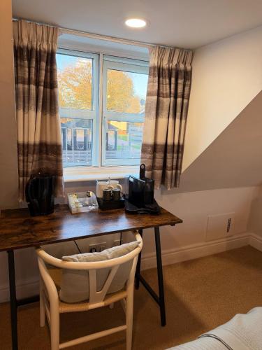 a desk in a room with a window at Rylands Farm Guest House in Wilmslow