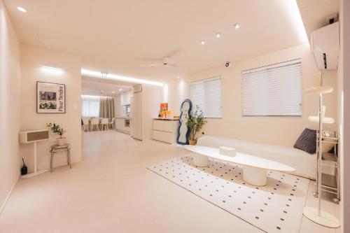 a white living room with a couch and a table at 207stay korea in Busan