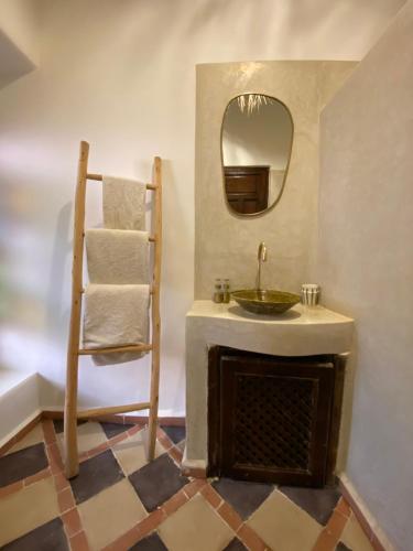 a bathroom with a sink and a mirror at Riad Musa in Marrakech