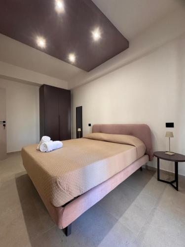 a bedroom with a large bed and a table at Amarcord in Laureana di Borrello
