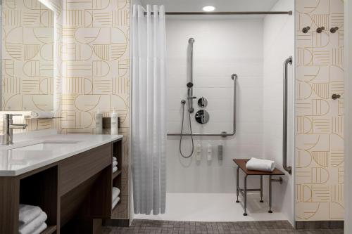 a bathroom with a shower and a sink at Home2 Suites By Hilton Woodstock On in Woodstock