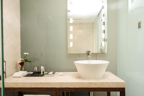 a bathroom with a sink and a mirror at The Park New Delhi in New Delhi