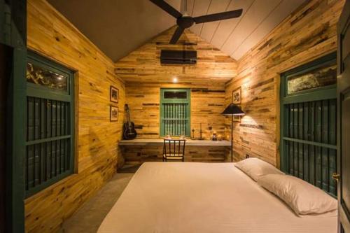 a bedroom with a bed in a wooden room at Maligathenna in Nikawatawana