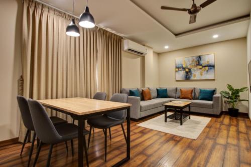 a living room with a table and a couch at Hotel Sukoon & Banquet Hall Near Bhopal Railway Station in Bhopal