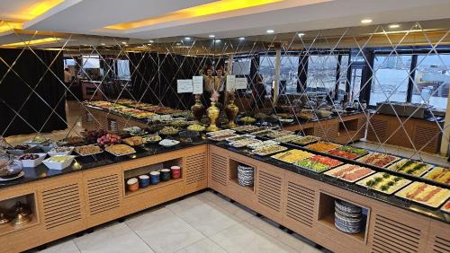 a buffet line with many different types of food at City Center Hotel Taksim İstanbul in Istanbul
