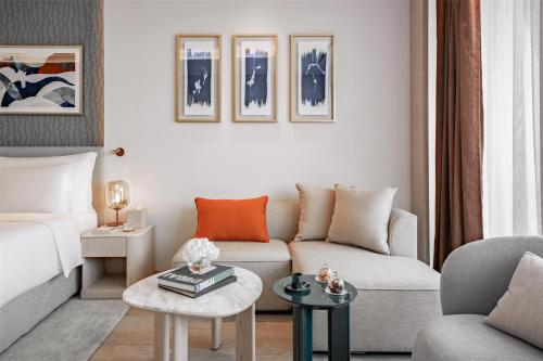 a living room with a couch and a table at The Meydan Hotel Dubai in Dubai