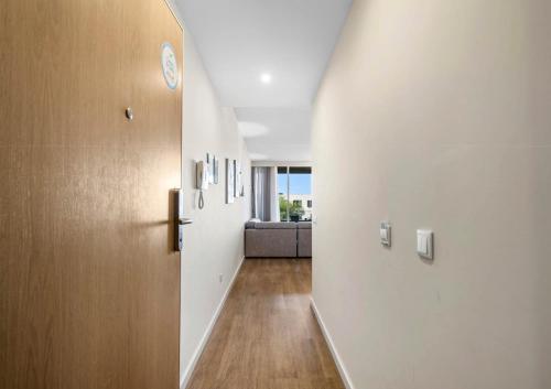 a hallway with white walls and a couch in a room at Madeira Mar - "Seaside" in Funchal