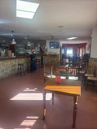 a person standing at a bar in a restaurant at Hostal Marcela Berge in Berge