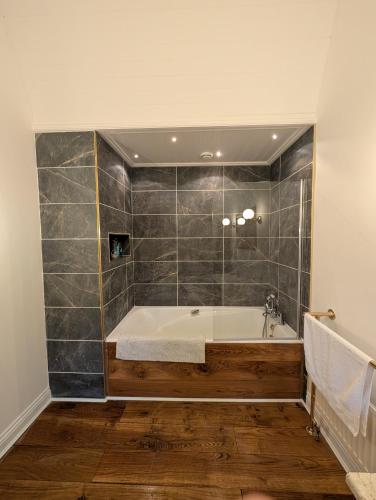 a bathroom with a bath tub in a room at Catstone Lodge in Ballymore