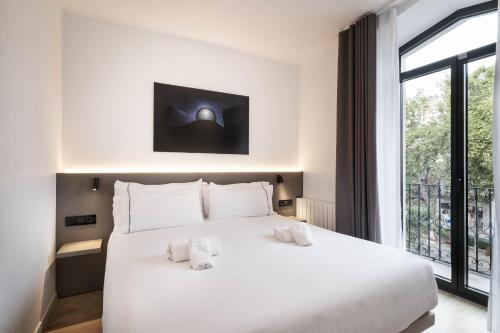 En eller flere senge i et værelse på NC Apartments Rambla 32