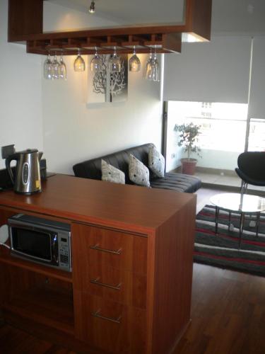 a kitchen with a microwave on top of a counter at Barceló Suites Providencia I in Santiago