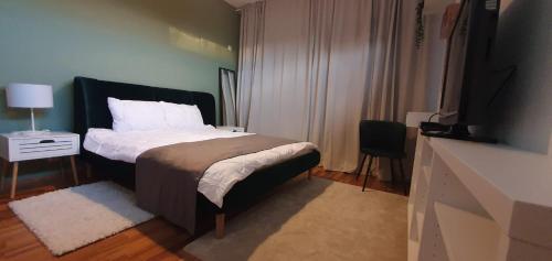 a bedroom with a bed and a television in a room at Apartament Baneasa Sisesti by Ale SELF CHECK-IN in Bucharest