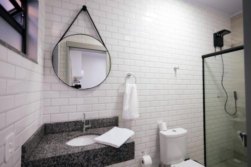 a bathroom with a sink and a mirror at Pousada Encantos de Itá in Itá