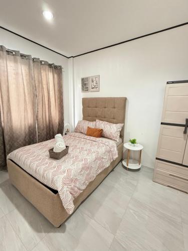 a bedroom with a large bed in a room at Casa VLOM Staycation in Roxas City