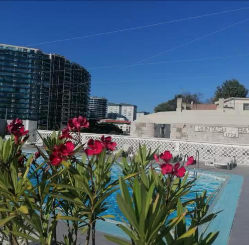 a view from the balcony of a hotel with red flowers at 2 Bedroom City Centre Gibraltar in Gibraltar