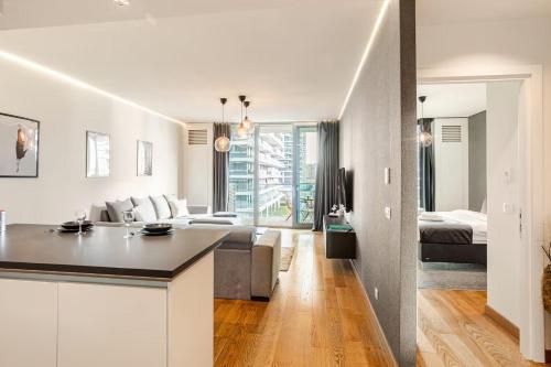 a kitchen and living room with a couch and a table at River View Belgrade Waterfront Luxury Appartment in Belgrade