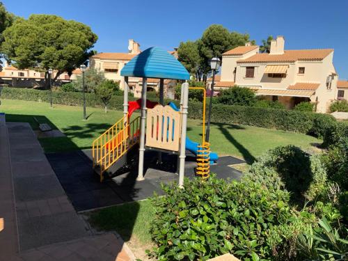 a child on a playground in a yard at La Casita Bonita del Faro Holiday Retreat in Gran Alacant in Gran Alacant