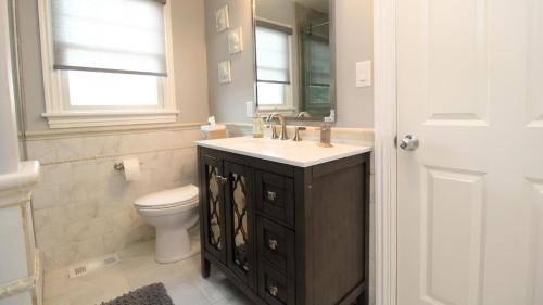 a bathroom with a sink and a toilet and a mirror at Family Tides in Cape May