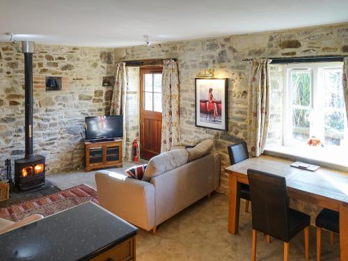 a living room with a couch and a fireplace at Turneys Cottage - Uk42115 in Bodmin
