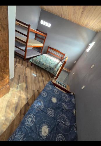 a attic room with two bunk beds and a rug at Marea Home in Arraial do Cabo