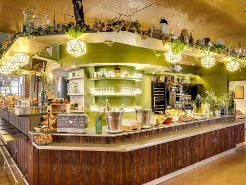 a restaurant with a counter with a lot of food at ibis Paris Bastille Opera in Paris