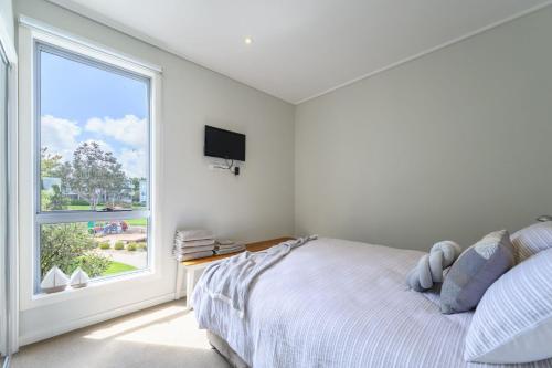 a bedroom with a bed and a large window at Sanny Side Up in San Remo
