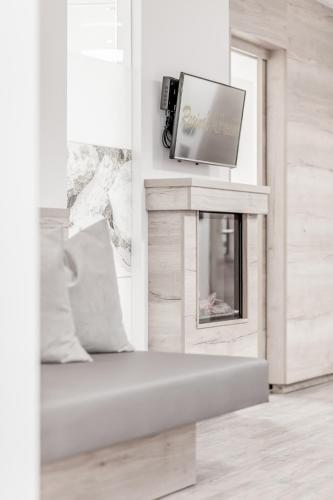 a living room with a tv and a fireplace at The Deluxe by Regina in Sölden