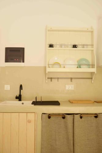 a kitchen with a sink and a counter top at The endless blue hide out in Ios Chora