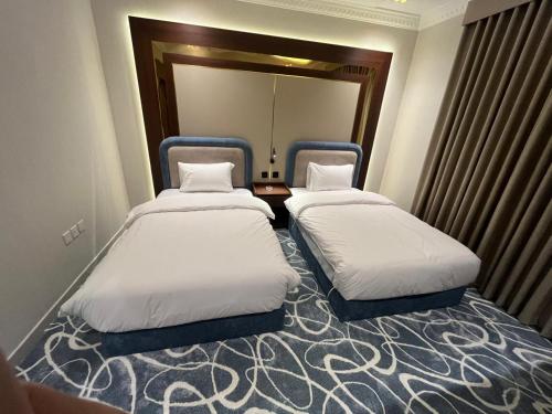 two beds in a hotel room with at العييري ريزيدنس in Dammam