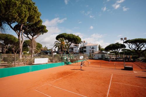a person playing tennis on a tennis court at Superb 3 BR Apartment - Beachfront - Old Town Cascais in Cascais