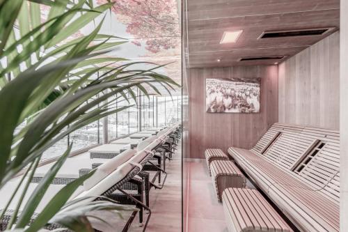 a row of benches in a building with a plant at The Deluxe by Regina in Sölden