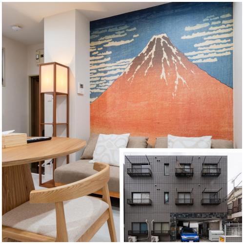a room with a table and a mountain mural at Lucky you! SHIBUYA in Tokyo