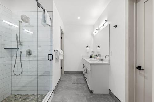 a white bathroom with a shower and a sink at 50 East 6th Ave A3 in Silverthorne