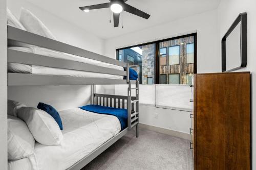 a bedroom with a bunk bed with a ceiling fan at 50 East 6th Ave A3 in Silverthorne