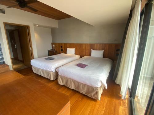 Una cama o camas en una habitación de PROSTYLE TERRACE NAHA