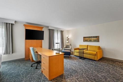 a hotel room with a desk and a couch at Hampton Inn Texarkana in Texarkana