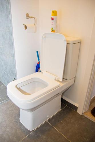 a bathroom with a toilet with the lid up at Moonlight mirage in Nairobi