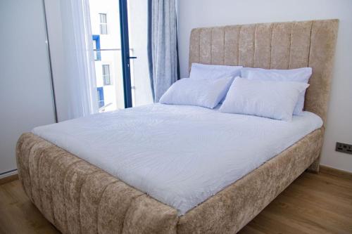 a large bed in a room with a large window at Moonlight mirage in Nairobi