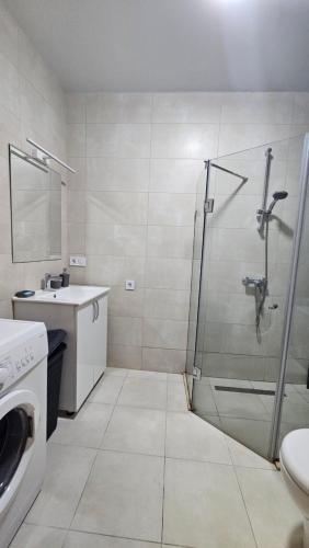 a bathroom with a shower and a sink at Студия в White Sails видовая in Batumi