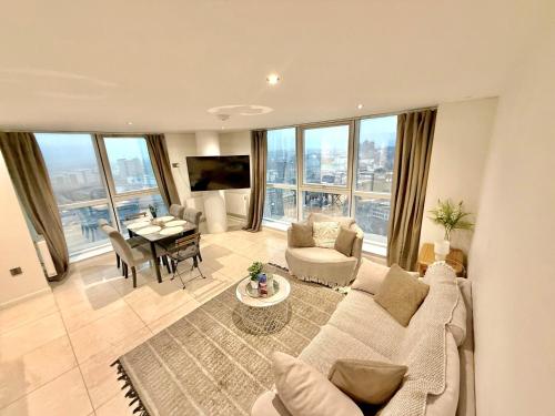 a living room with a couch and a table at 22nd Floor Luxury City Centre Apartment in Belfast