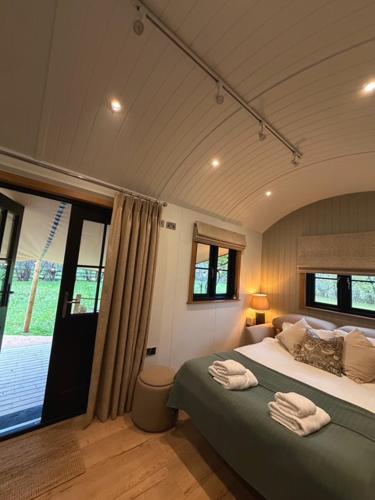 a bedroom with a bed with two towels on it at Rylands Farm Guest House in Wilmslow