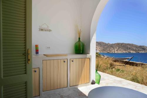 an archway leading to a kitchen with a view of the ocean at The endless blue experience in Ios Chora