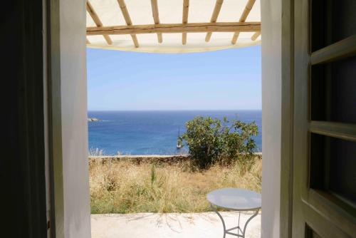 a view of the ocean from a window at The endless blue experience in Ios Chora
